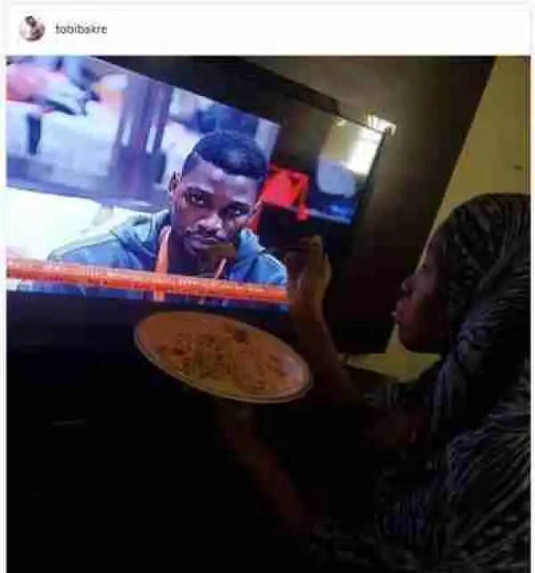 #BBNaija: Check Out How A Fan Is Feeding Tobi Through The TV; Nigerians react (Photos)